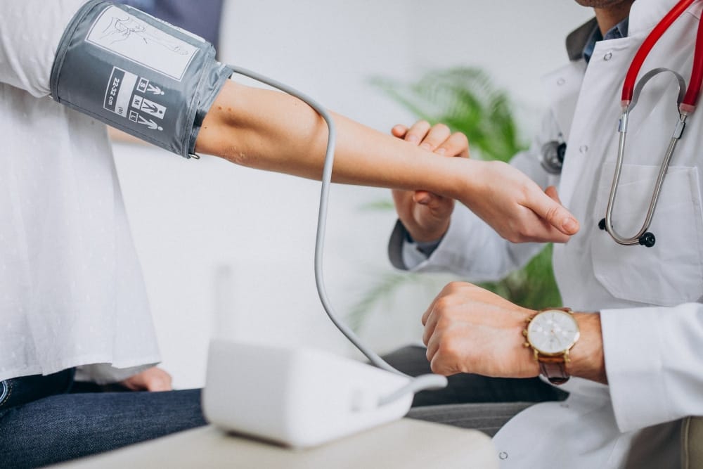 a doctor checking a patient's blood pressure