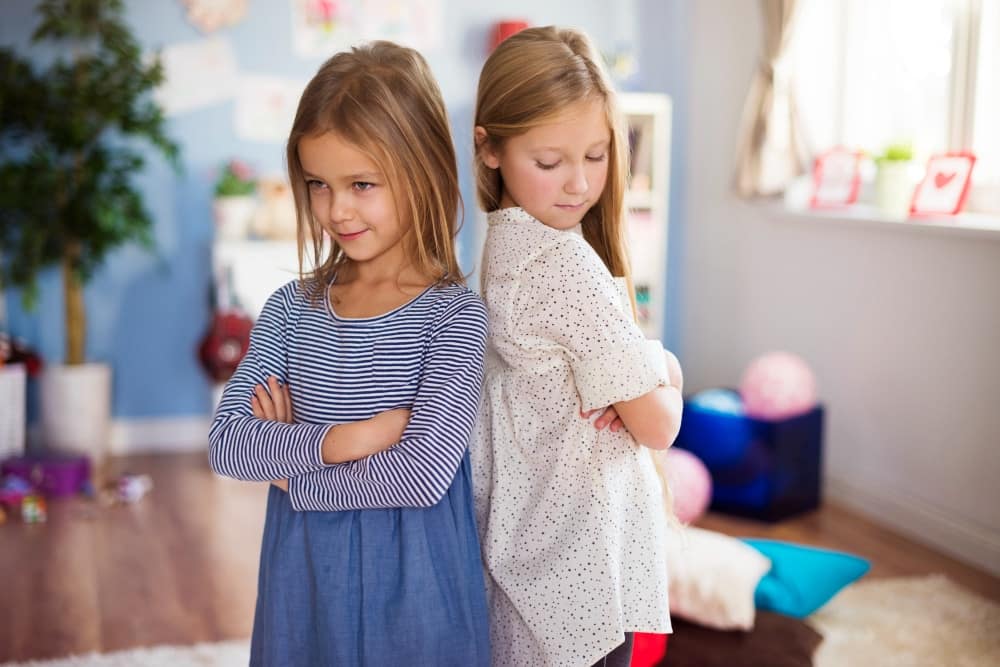 Sulking girls standing back to back
- How To Help Your Kids Make Friends
