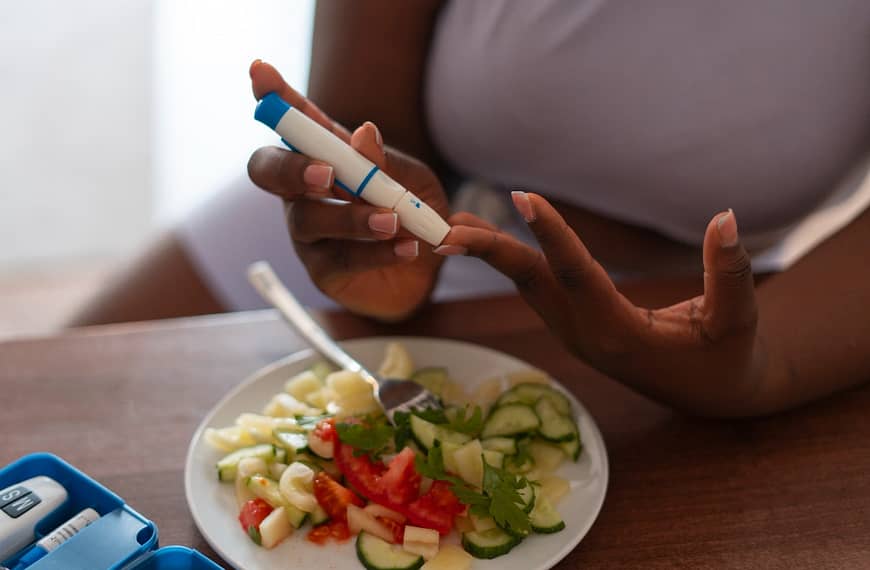 a person holding a device to test the blood sugar for the blog- what is diabetes